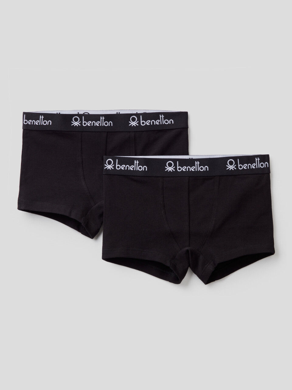 Two black boxers with logoed elastic