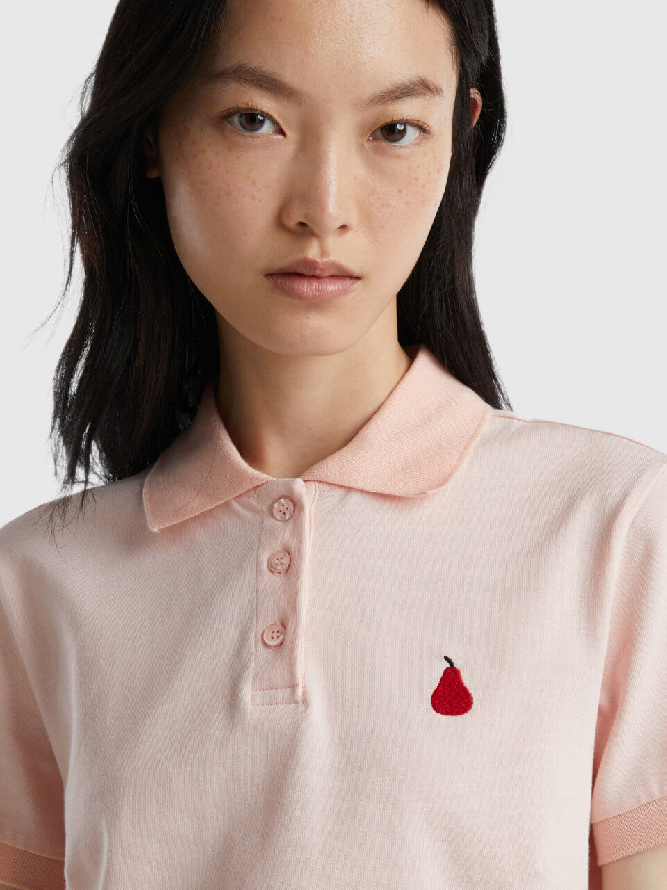 Pink polo with pear embroidery